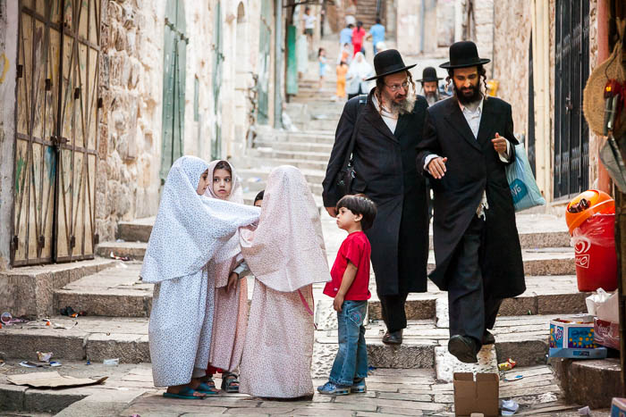 Orthodox Jewish men and Muslim children in Jerusalem (2006)